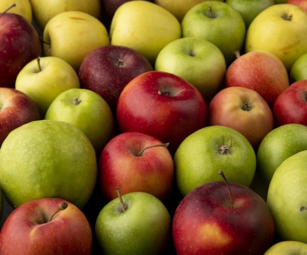 side view apple mix green yellow and red apples on black background