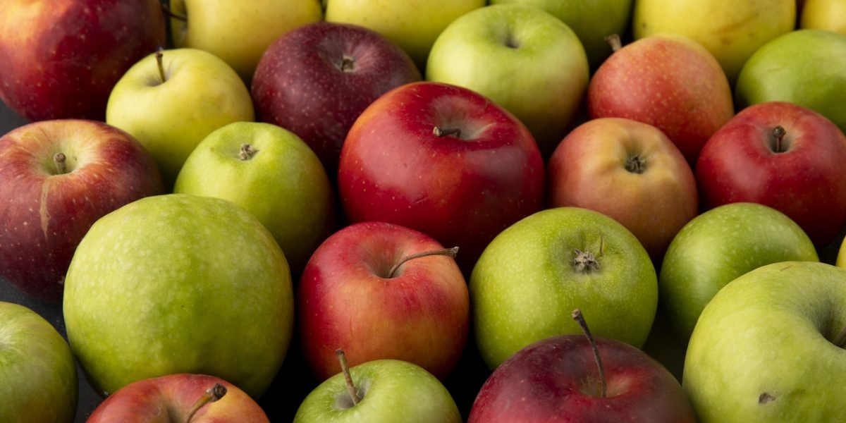 side view apple mix green yellow and red apples on black background