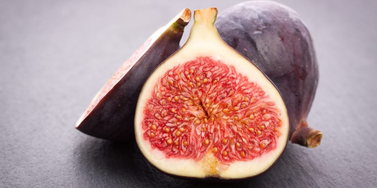 Fresh figs on black stone background